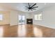 Living room with hardwood floors, fireplace, and access to balcony at 1405 Willow Oak Rd, Castle Rock, CO 80104