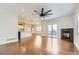 Bright living room with hardwood floors, fireplace, and sliding glass doors leading to a deck at 1405 Willow Oak Rd, Castle Rock, CO 80104