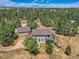 Aerial view of a home with guest house surrounded by trees at 1817 Buttercup Rd, Elizabeth, CO 80107