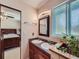 The bathroom features a double sink vanity and decorative mirrors plus entrance to main bedroom at 1817 Buttercup Rd, Elizabeth, CO 80107