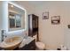 The bathroom offers a single sink with unique wood vessel sink, stylish mirror and wood accents at 1817 Buttercup Rd, Elizabeth, CO 80107