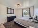 This bedroom features a dresser and two windows with natural light and neutral decor at 1817 Buttercup Rd, Elizabeth, CO 80107