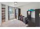 A bedroom featuring a desk, a wardrobe and a window with backyard views and neutral decor at 1817 Buttercup Rd, Elizabeth, CO 80107