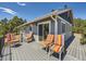 This outdoor deck features striped seating, sliding glass doors, and views of the natural surroundings at 1817 Buttercup Rd, Elizabeth, CO 80107