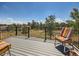 Relax on this outdoor deck with views of the surrounding nature and vibrant seating at 1817 Buttercup Rd, Elizabeth, CO 80107