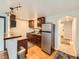 This is a well-lit kitchen with stainless steel appliances, dark cabinetry and wood flooring at 1817 Buttercup Rd, Elizabeth, CO 80107