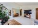 Living room featuring a piano, large TV, and plants at 1817 Buttercup Rd, Elizabeth, CO 80107