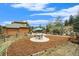 Spacious backyard featuring a patio, play area, and mature trees at 31755 Ponderosa Way, Evergreen, CO 80439
