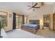 Bright bedroom features vaulted ceilings, a ceiling fan, and sliding glass doors to a balcony at 31755 Ponderosa Way, Evergreen, CO 80439