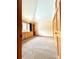 Bedroom with built-in wooden shelving, large windows with blue curtains, and a neutral carpet at 31755 Ponderosa Way, Evergreen, CO 80439