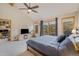 Cozy bedroom with an electric fireplace, carpet, and access to an office space at 31755 Ponderosa Way, Evergreen, CO 80439
