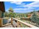 Enjoy stunning mountain views from this beautiful deck with wood railings and ample space for outdoor entertaining at 31755 Ponderosa Way, Evergreen, CO 80439