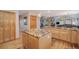 Open kitchen design featuring wooden cabinetry, granite countertops, and seamless flow to the living area at 31755 Ponderosa Way, Evergreen, CO 80439