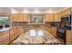 A bright kitchen featuring wooden cabinets, stainless steel appliances, and stunning granite countertops at 31755 Ponderosa Way, Evergreen, CO 80439