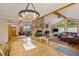 Open floor plan featuring a river rock fireplace, hardwood floors, and plenty of natural light at 31755 Ponderosa Way, Evergreen, CO 80439