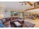 Open living area with wood floors, comfortable seating and access to outdoor spaces at 31755 Ponderosa Way, Evergreen, CO 80439
