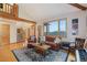 Cozy living room featuring hardwood floors and a large window with great mountain views at 31755 Ponderosa Way, Evergreen, CO 80439