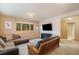 Inviting living room with carpet, comfortable seating, and a modern entertainment center at 31755 Ponderosa Way, Evergreen, CO 80439