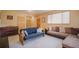 Spacious living area with ample seating, a piano, and natural light at 31755 Ponderosa Way, Evergreen, CO 80439