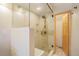 Walk-in shower featuring glass door, tile surround and seating at 31755 Ponderosa Way, Evergreen, CO 80439