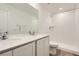 Bathroom featuring dual sinks, white cabinets, stone countertops, and a walk-in shower at 21996 E 39Th Pl, Aurora, CO 80019