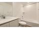 Bright bathroom featuring a tub with white subway tile surround, light wood floor, and white vanity with quartz countertop at 21996 E 39Th Pl, Aurora, CO 80019