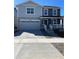 Two-story home featuring a two-car garage, covered porch, and a combination of stone and siding exterior at 21996 E 39Th Pl, Aurora, CO 80019