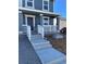 Inviting front porch with white railing, concrete steps, and gravel landscaping at 21996 E 39Th Pl, Aurora, CO 80019
