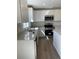 Close-up of the kitchen with stainless steel appliances, light countertops, white cabinets, and a sink at 21996 E 39Th Pl, Aurora, CO 80019