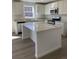 Kitchen showcasing an island with light countertop, wood flooring, and stainless steel appliances at 21996 E 39Th Pl, Aurora, CO 80019