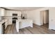 Modern kitchen with white cabinets, stainless steel appliances, quartz countertops, and an island at 21996 E 39Th Pl, Aurora, CO 80019