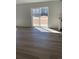 Living room featuring wood-like flooring and a sliding glass door with natural light at 21996 E 39Th Pl, Aurora, CO 80019