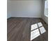 Living room featuring wood-like flooring, natural light from a window and light-colored walls at 21996 E 39Th Pl, Aurora, CO 80019