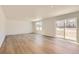 Bright and spacious living room with hardwood flooring and sliding glass doors to the backyard at 21996 E 39Th Pl, Aurora, CO 80019