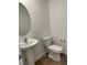 Powder room featuring a pedestal sink, toilet, and neutral wall paint at 21996 E 39Th Pl, Aurora, CO 80019