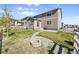 Backyard featuring a new patio, fire pit, white fence, and grass at 2576 Villageview Ln, Castle Rock, CO 80104