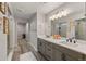 Stylish primary bathroom featuring double vanity, quartz countertops, and a walk-in shower with glass doors at 2576 Villageview Ln, Castle Rock, CO 80104