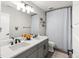 Stylish bathroom with a double sink vanity, modern fixtures, and a shower curtain at 2576 Villageview Ln, Castle Rock, CO 80104