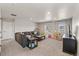 Spacious bonus room with large sectional sofa, two windows, and neutral carpeting at 2576 Villageview Ln, Castle Rock, CO 80104