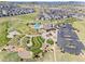 Aerial view showcasing community amenities including a pool, clubhouse, playground, and green space at 2576 Villageview Ln, Castle Rock, CO 80104