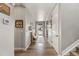 Entryway with a light-colored floor, decorated bench, white door and trim, and access to the staircase at 2576 Villageview Ln, Castle Rock, CO 80104
