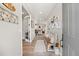 Inviting entryway featuring light gray walls, wood floors, decorated bench, and clear view of the living room beyond at 2576 Villageview Ln, Castle Rock, CO 80104