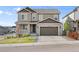 Charming two-story home featuring a two-car garage, well-maintained lawn, and inviting front porch with white railings at 2576 Villageview Ln, Castle Rock, CO 80104