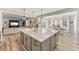 Open concept kitchen island with sink that connects to living room and dining area with plenty of natural light at 2576 Villageview Ln, Castle Rock, CO 80104