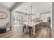 Open concept kitchen featuring an island with barstool seating and a view of the sunny dining area at 2576 Villageview Ln, Castle Rock, CO 80104