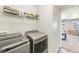 Convenient laundry room equipped with modern washer and dryer, plus ample storage space at 2576 Villageview Ln, Castle Rock, CO 80104