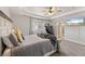 Cozy main bedroom with a tray ceiling, ceiling fan, and neutral color palette at 2576 Villageview Ln, Castle Rock, CO 80104