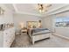 Comfortable main bedroom with tray ceiling, ceiling fan, neutral tones, and large windows at 2576 Villageview Ln, Castle Rock, CO 80104