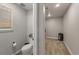 Powder room with toilet next to a storage area with neutral color and nice interior lighting at 2576 Villageview Ln, Castle Rock, CO 80104