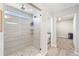 Modern bathroom featuring tiled shower with sleek glass door and natural light from above window at 2576 Villageview Ln, Castle Rock, CO 80104